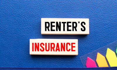 the word RENTER'S INSURANCE is written on a wooden cubes structure.