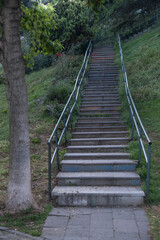path and steps in the public park, concrete stairs on grass field