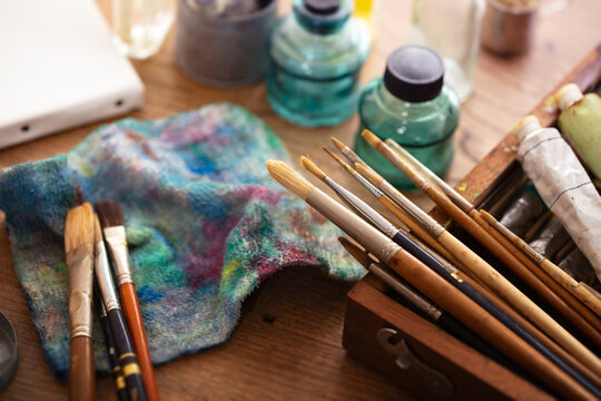 Oil painting preparation. Old painting brushes and equipment  on an old painters desk. 