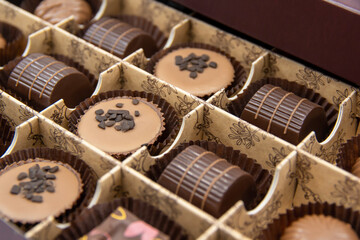 Chocolate candies set in an open box. Chocolate candy closeup. Assorted chocolate sweets.	