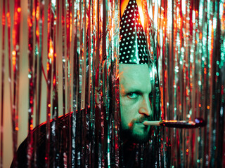 Boring party. Silly man. Birthday celebration. Holiday fun. Ridiculous skeptic guy wearing festive...