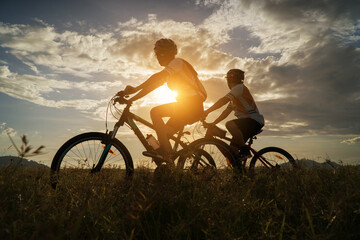 Young Couple in love fun and happy riding mountain bike after covid-19 coronavirus outbreak. End of...