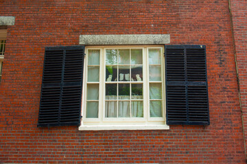 Antique window on the historic row houses on Acorn Street on Beacon Hill in historic city center of Boston, Massachusetts MA, USA. 