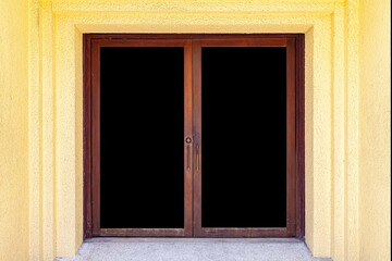 The large entrance door brown solid wood building and Yellow cement wall