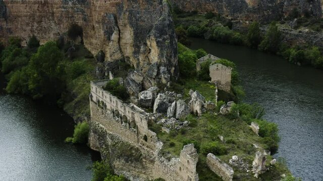 Ruins Of Convent Of Our Lady Of The Angels De La Hoz On Rocky Cliff By The River In Sebulcor, Segovia, Spain. aerial ascend