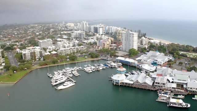 Aerial View Of Luxury Yachts And Boats Moored On Jetty By Mooloolaba River With Seafood Restaurant  And Beachfront Hotels In QLD, Australia.