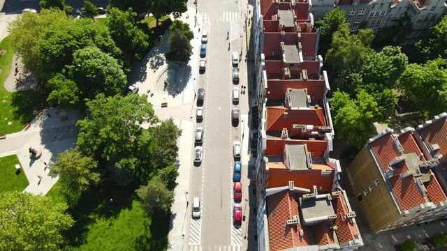 Aerial view of street near the park in Old Town Gdansk with many cars parked near the buildings in summer
