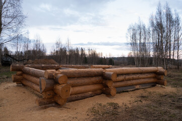 unfinished wooden log house. Construction of an environmentally friendly house made of wood. Walls, floor and ceiling of an unfinished house made of natural material, logs