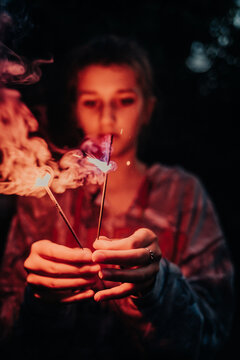 girl playing with sparklers 4th of July
