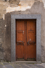 Fototapeta na wymiar Ancient, rustic door and weathered, peeling paint in the Tuscany region of Italy 