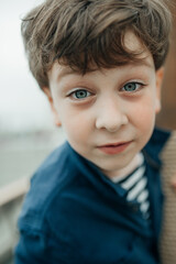 funny shaggy tousled boy with light skin and blue eyes. large vertical portrait, selective focus