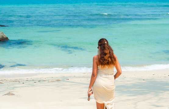 young pretty woman walking relaxing, on  summer beach