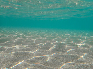 underwater blue ocean wide background with sandy sea bottom, Real natural underwater view of the Mediterranean Sea