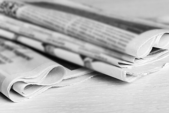 Media news concept, stack of newspapers on the desktop. Selective focus, blur.