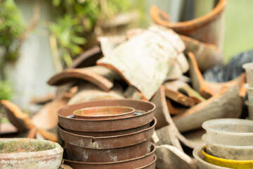 various used plastic and clay pots for plant covered with dirt