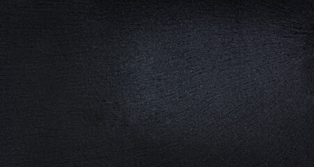 Black background with texture. Cutting board made of stone