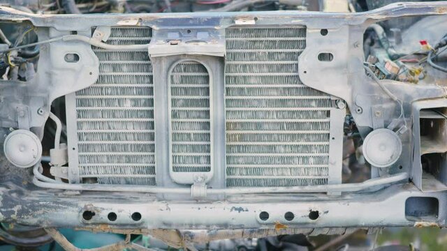Rusted hulk wreck of radiator car machine engine partially, old metal abandoned car