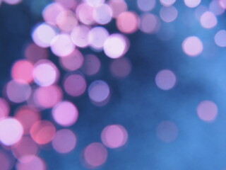 Beautiful side on a dark background. Pink shimmer and circles on a blue and gray background. Festive abstract background