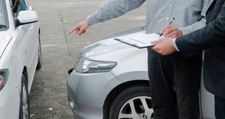 Loss Adjuster Insurance Agent Inspecting Damaged Car. .Sales manager giving advice application form document considering mortgage loan offer for car  insurance