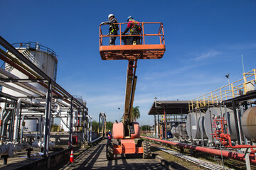 Two male  industry working at high in a boom lift © chitsanupong