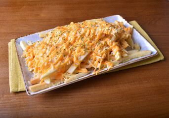 deep fried golden French fries with parmesan cheesy sauce in white background western snack cuisine halal fast food menu