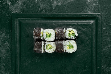 Maki sushi roll with cucumber. Classic Japanese cuisine. Food delivery. Black background