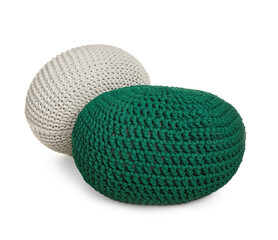 Different stylish knitted poufs on white background