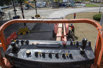 Male control boom lift in a industry working at high © chitsanupong