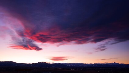 ominous clouds  at sunset over long's peak and the front range, as seen from broomfield, colorado 