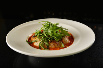 cheesy baked cheese meat ball with red tomato bolognese sauce and green vegetables in dark bar counter background western cuisine halal menu