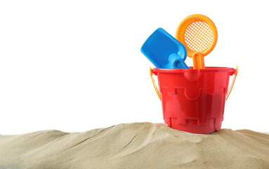 Plastic toy set with shovel on pile of sand