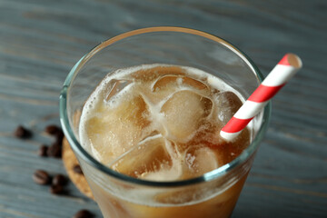 Glass of ice coffee with straw, close up