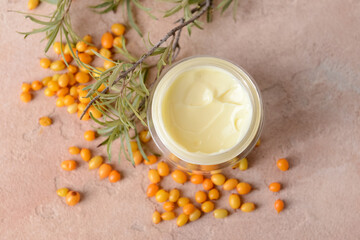 Fototapeta na wymiar Jar of healthy sea buckthorn cream on color background