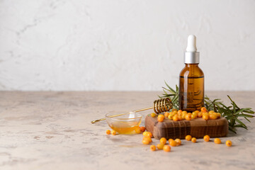 Bottle of healthy sea buckthorn oil on table