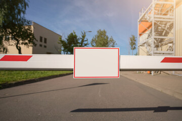 Empty white signage in red frame hanging on road barrier