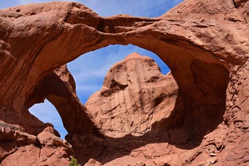 Fototapeta na wymiar double arch red rock formation on a sunny day in arches national park, near moab, utah