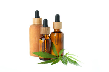 Dropper bottles and cannabis leaves isolated on white background