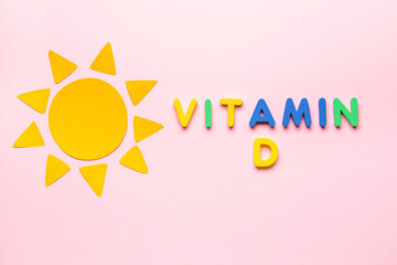 Text VITAMIN D with sun on color background
