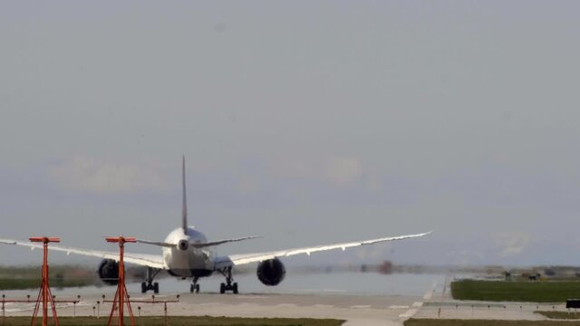 Rear View Of An Airplane Moving On The Runway For Takeoff At Vancouver International Airport In Canada. wide shot