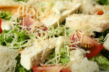 Tasty Caesar salad on whole background, close up
