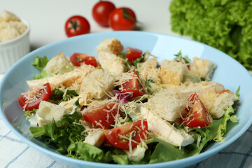 Concept of tasty eating with Caesar salad on white background