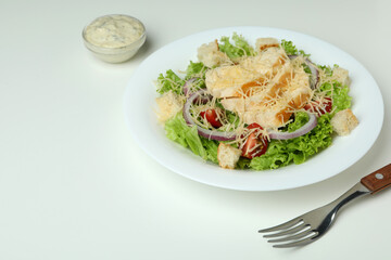 Concept of tasty eating with Caesar salad on white background