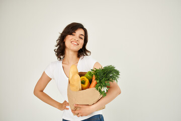 cheerful woman in a white t-shirt package with groceries from the supermarket health