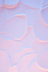 Abstract neon pink and blue sand texture with flat curved rounded surfaces. Disco style background.