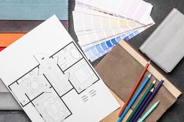 Composition with paint color palettes and house plan on dark background