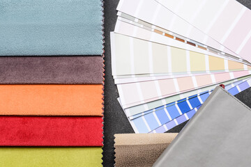 Composition with paint color palettes and fabric samples on dark background