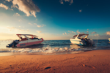 Speed boat at the sea beach and sunset.