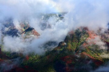  tendrils of afternoon fog   in  colorful waimea canyon in kauai, hawaii       