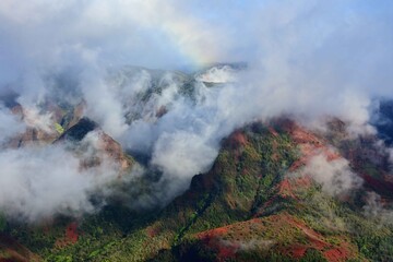  afternoon fog rolls in  over colorful  waimea canyon, kauai, hawaii     
