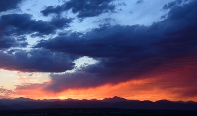 colorful sunset over long's peak and  the front range of the colorado rocky mountains as seen from Broomfield, colorado